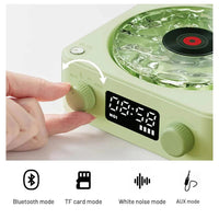 Mini Retro White Noise Bluetooth Speaker in light green with textured top, digital display, and control knobs being adjusted
